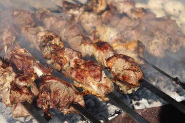 Pork Skewers in the smoke on the grill. Grilled pork.