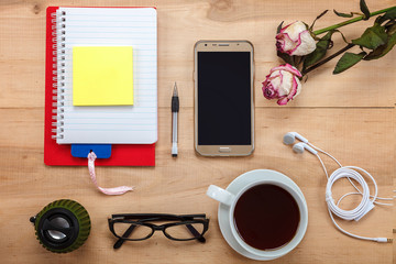 Mobile phone, glasses, cup of tea, flowers, stationery