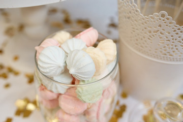 White and pink meringues in a jar