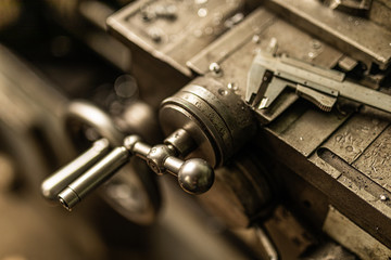 old lathe knob with caliper in ironworks factory closeup