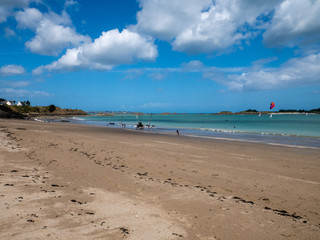 Fototapeta na wymiar French sunny beach at low tide full of shells and fine sand.