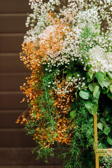 The wedding arch is decorated with small white flowers and flower arrangements of pink and white flowers (hydrangea and gypsophila). Wedding floristics.