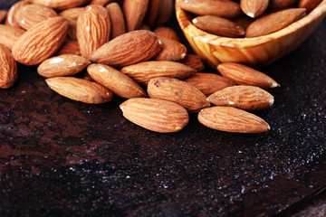 Almonds on a rustic background and almond in bowl.