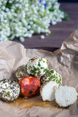 Labne balls with herbs and spices on craft paper. Traditional yogurt cream cheese in the Middle East. Vegetarian food.