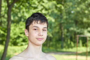 Fototapeta na wymiar Portrait happy teenager on the nature background