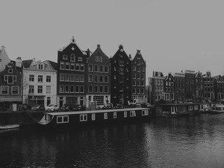 a tristesse view of a canal with old houses of Amsterdam