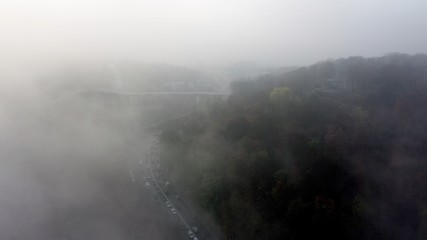 A city covered in fog. City traffic, aerial view