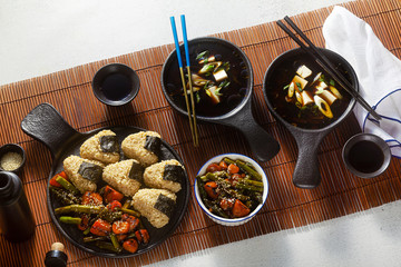 Japanese breakfast with miso soup, onigiri and vegetables in sweet and sour sauce. Typical traditional morning food