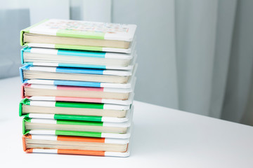 Children's books are stacked on a table in a room. Child development with books concept