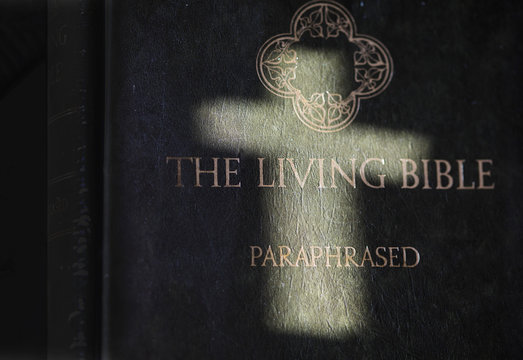 Ukraine, Kiev - April 23, 2020: Holy Bible.  Text in hebrew. Christian background with a glowing cross.