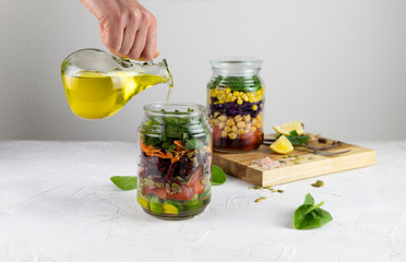 Healthy vegetarian Homemade Mason Jar fresh Salad with Chickpea and Veggies on a light background.Diet, Detox, Clean Eating, Vegan raw food concept.