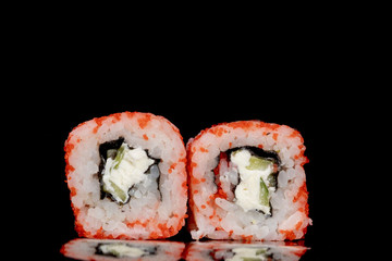 Philadelphia roll with salmon, cheese and cucumber on a black background with reflection. Sushi Philadelphia