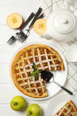 Composition with apple pie on white wooden background. Tasty lunch. Homemade breakfast