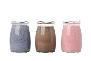 Blueberry, strawberry and chocolate milkshakes isolated on white background
