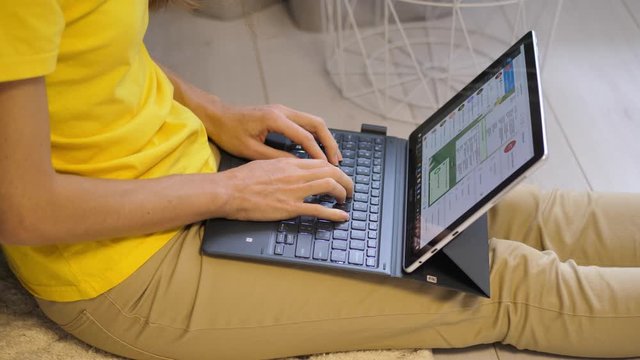 Caucasian woman working from home, checking documents on laptop. Stay home, quarantine remote work