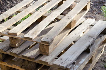 Wooden pallets at a construction site. A stack of wooden pallets.