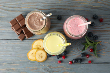 Delicious milkshakes on wooden background. Summer drink