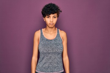 Young beautiful african american afro sportswoman doing exercise wearing sportswear depressed and worry for distress, crying angry and afraid. Sad expression.