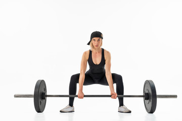 Fototapeta na wymiar Young woman doing deadlift with a barbell isolated on white. Front view