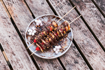 Homemade mini crepe and strawberry skewers on table