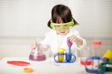 toddler girl pretend play scientist role for homeschooling