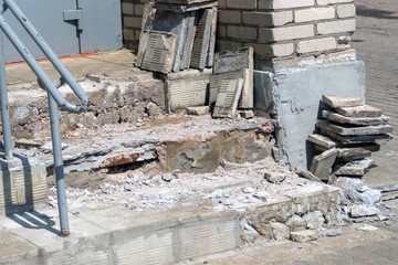 Concrete porch repair. Tile removed and stacked next to it.