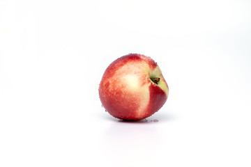 ripe peach with drops of water, isolate on white
