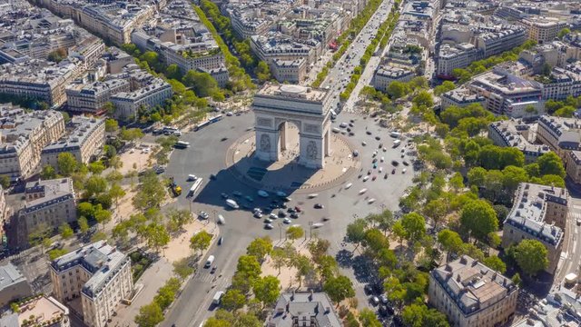 flight over paris city sunny day famous triumph arch traffic circle streets aerial timelapse panorama 4k france