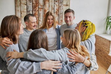 caucasian people stand hug and support each other, alcohol addicts gathered in office