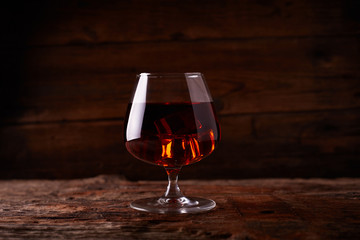 Glass of whiskey on wooden table