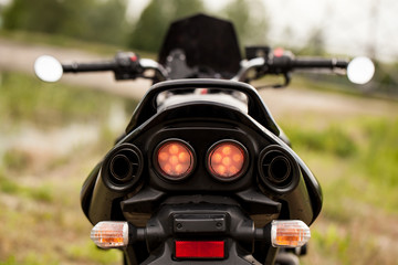 Sports black motorcycle near the power plant.
