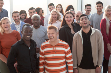 Happy confident business team stands in office