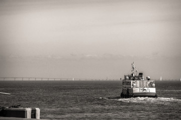 Boat sailing on the river in black and white in Lisbon