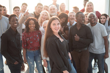 confident young woman standing in front of a group of her friends