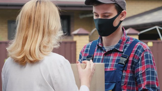 Courier brings parcel to the recipient's house, woman picks it up