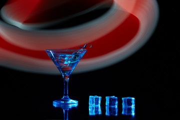 Neon martini glass shot with long exposure. Red club lights.