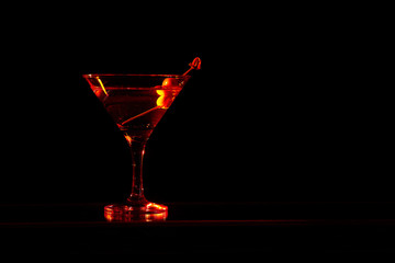 French Martini cocktail, consisting of vodka, raspberry liqueur and freshly squeezed pineapple juice. Isolated on black background.
