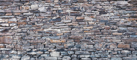 Wall made of natural flat rocks, flatbed stones structure wall texture background