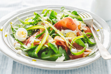 Summer salad with ham, asparagus, eggs and cheese