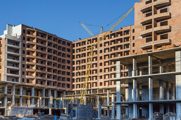 Extensive scaffolding providing platforms for work in progress on a new apartment block,Tall...