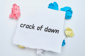 Crack of dawn - english idiom hand lettering on wooden blocks