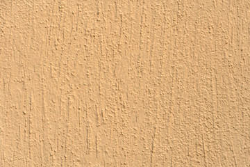 Empty orange background, texture, textured plaster on the wall. Building facade repair.
