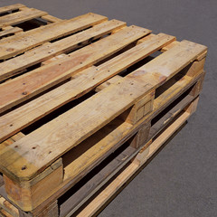 Used wooden pallets lying on the asphalt pavement