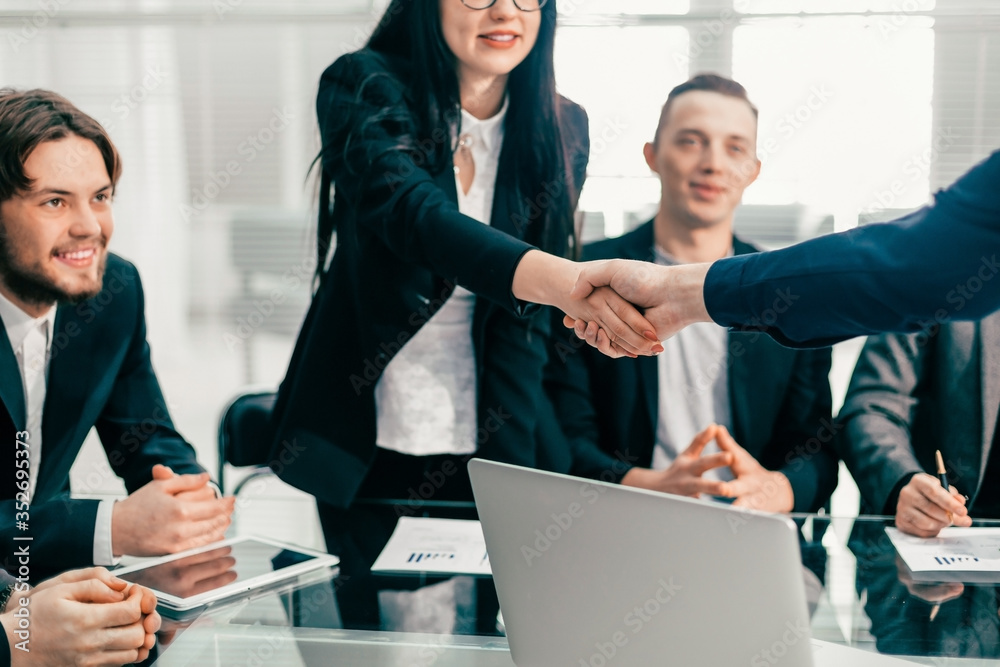 Wall mural business colleagues greeting each other at an office meeting.