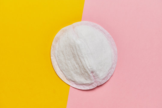 Women pad for bra on a yellow and pink background with a top view