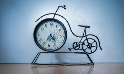 vintage clock Bicycle on a table on a white background