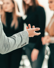 cropped image of a speaker making a presentation at a seminar.