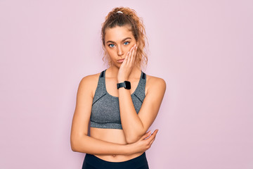 Young beautiful blonde sportswoman with blue eyes doing exercise wearing sportswear thinking looking tired and bored with depression problems with crossed arms.