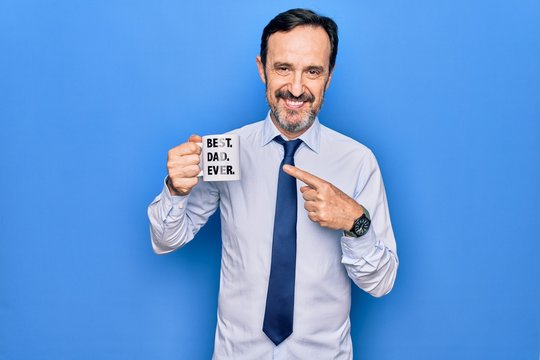 Middle age elegant business man drinking cup of coffee with best dad ever message smiling happy pointing with hand and finger