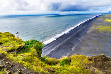 Fototapeta na wymiar Green Cliff Waves Peebles Dyrholaey Park Reynisfjara Black Sand Beach Iceland